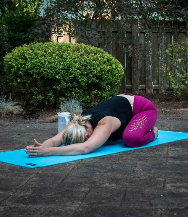 girl doing child yoga pose